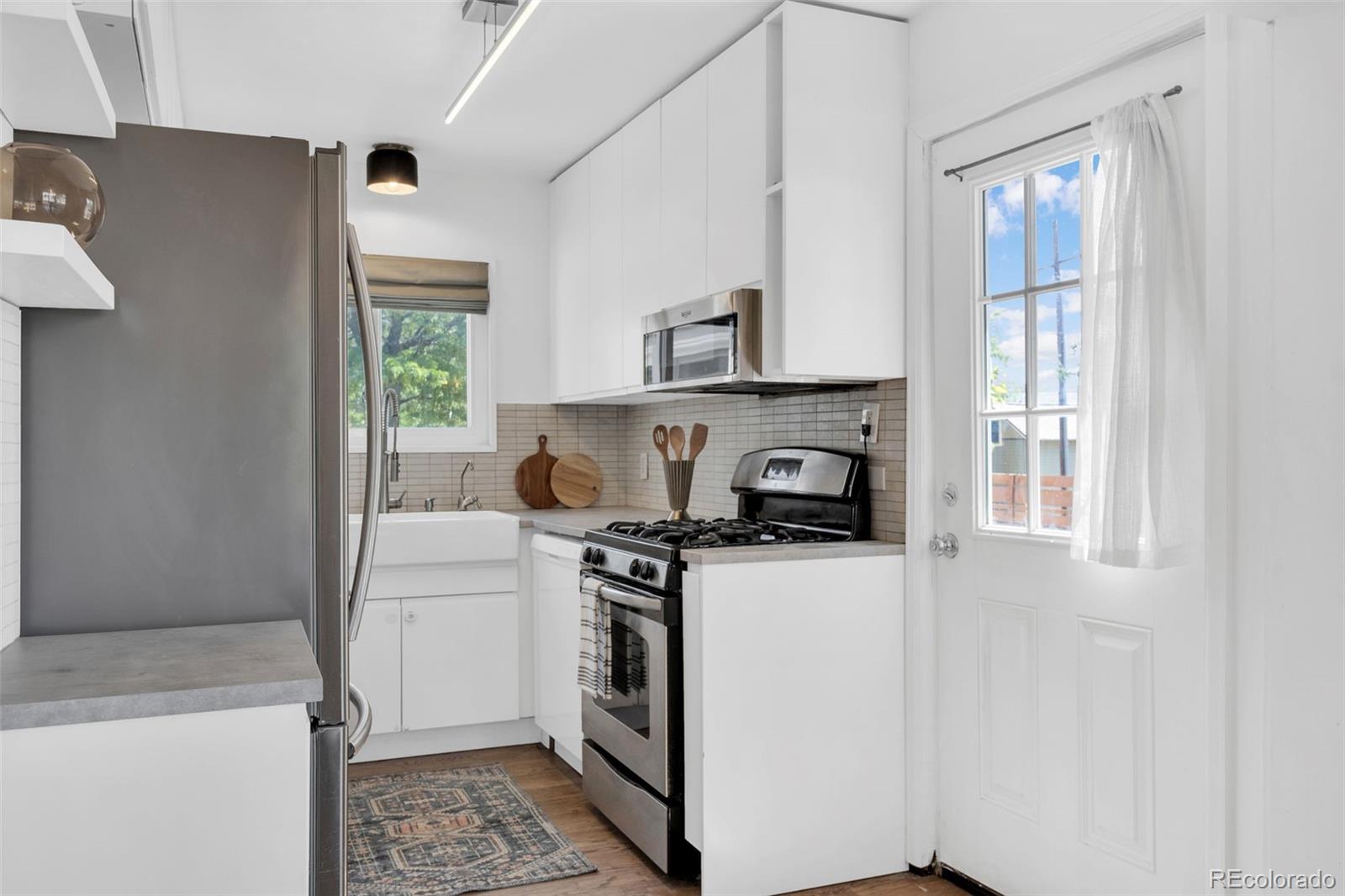 2900 Benton Street Wheat Ridge, CO 80214 - Photo 11 of 43 a kitchen with a stove and a refrigerator