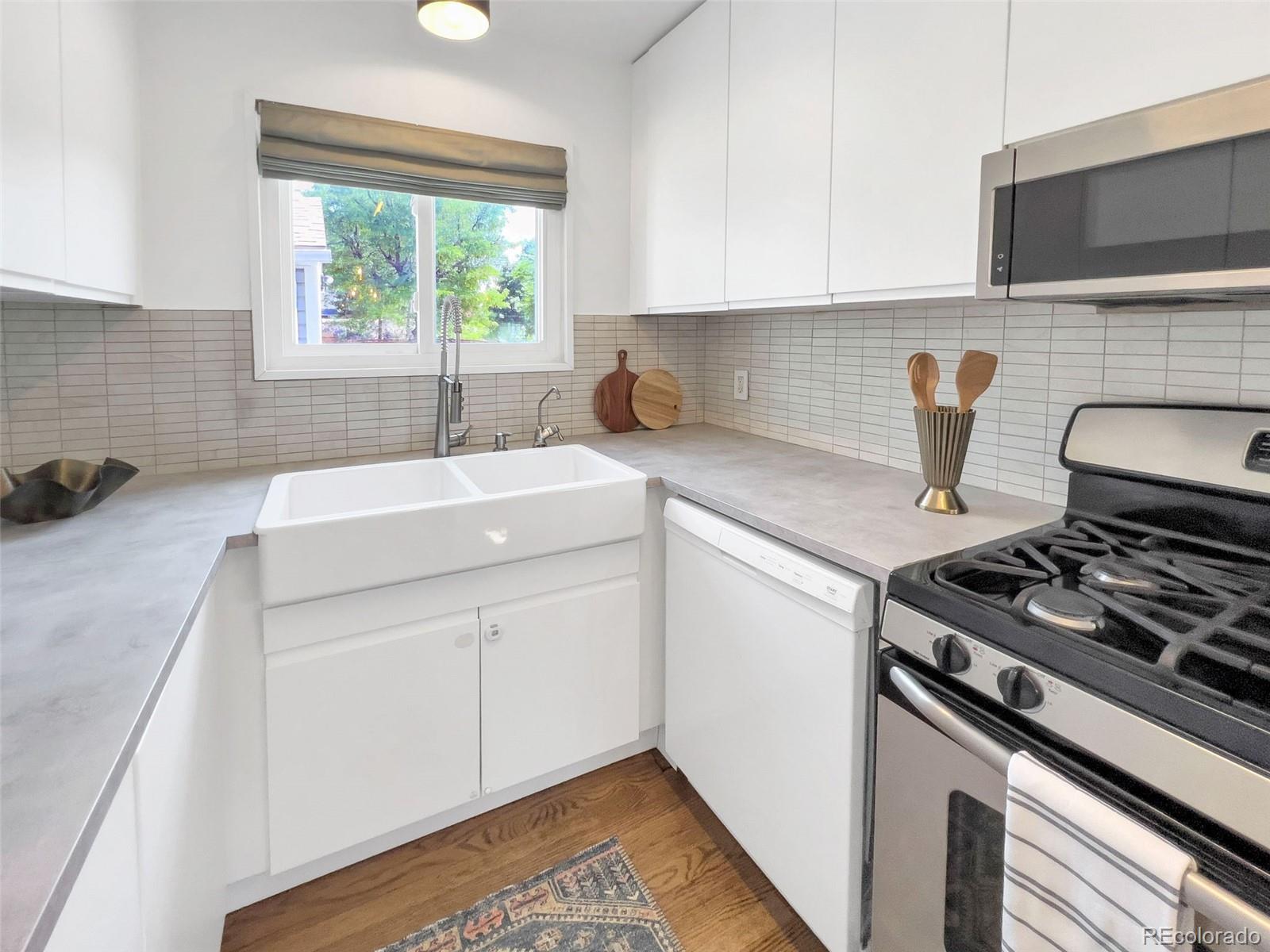 2900 Benton Street Wheat Ridge, CO 80214 - Photo 12 of 43 a kitchen with a sink stove and cabinets
