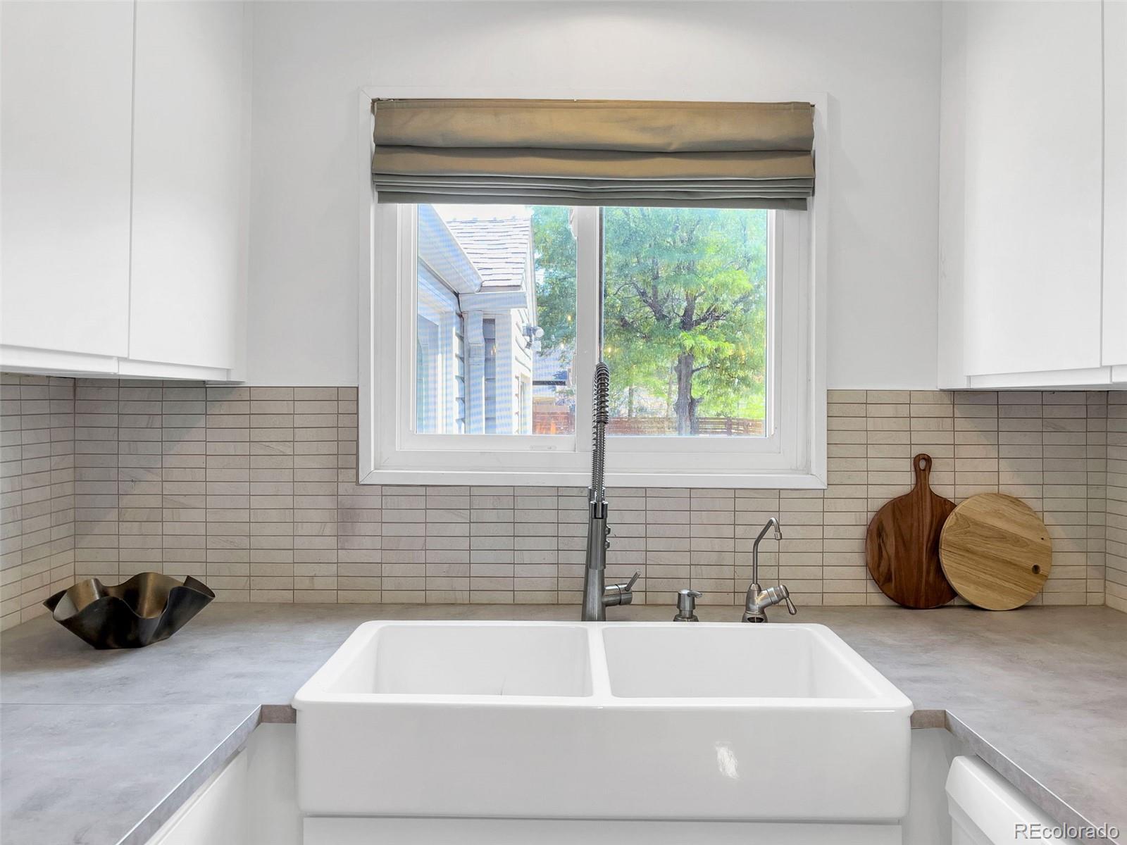 2900 Benton Street Wheat Ridge, CO 80214 - Photo 14 of 43 a bathroom with a tub a sink and a window