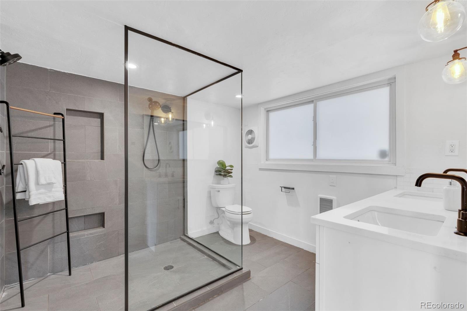2900 Benton Street Wheat Ridge, CO 80214 - Photo 21 of 43 a bathroom with a shower and a sink