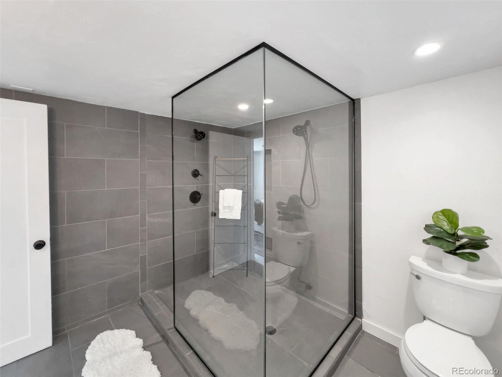 2900 Benton Street Wheat Ridge, CO 80214 - Photo 23 of 43 a bathroom with a shower a toilet and sink