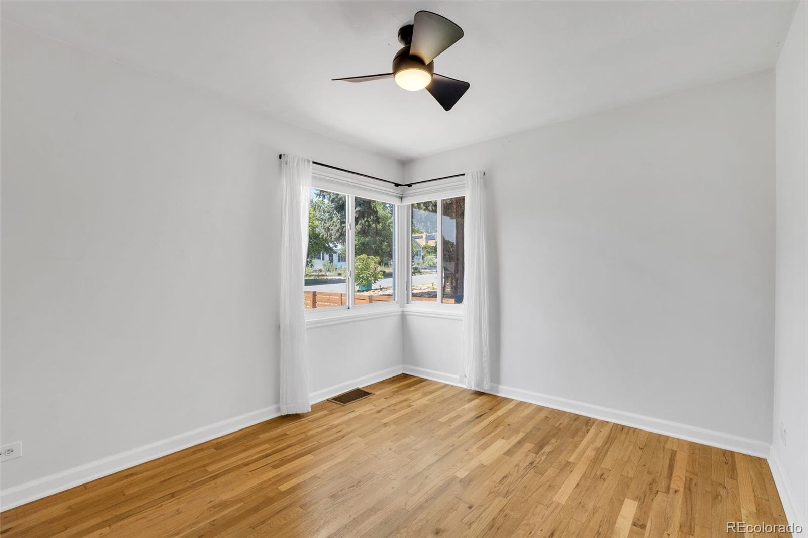 2900 Benton Street Wheat Ridge, CO 80214 - Photo 25 of 43 a view of empty room with wooden floor and fan