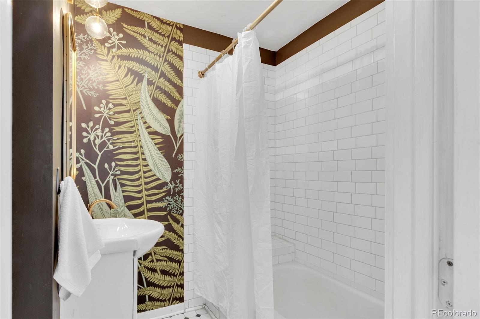 2900 Benton Street Wheat Ridge, CO 80214 - Photo 28 of 43 a bathroom with a shower and a curtain