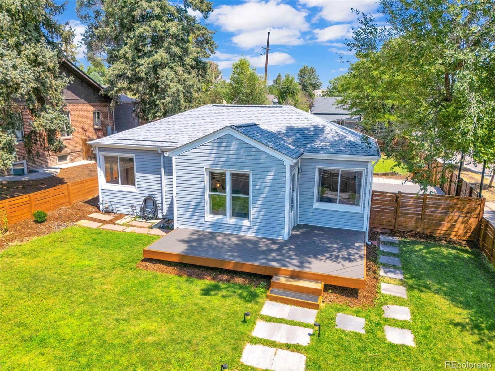 2900 Benton Street Wheat Ridge, CO 80214 - Photo 39 of 43 a front view of house with a garden and patio
