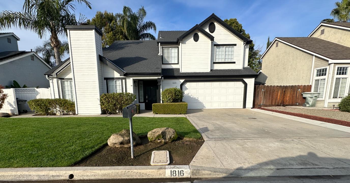 1816 East Frederick Avenue Fresno, CA 93720 - Photo 1 of 29 a front view of a house with a yard and garage