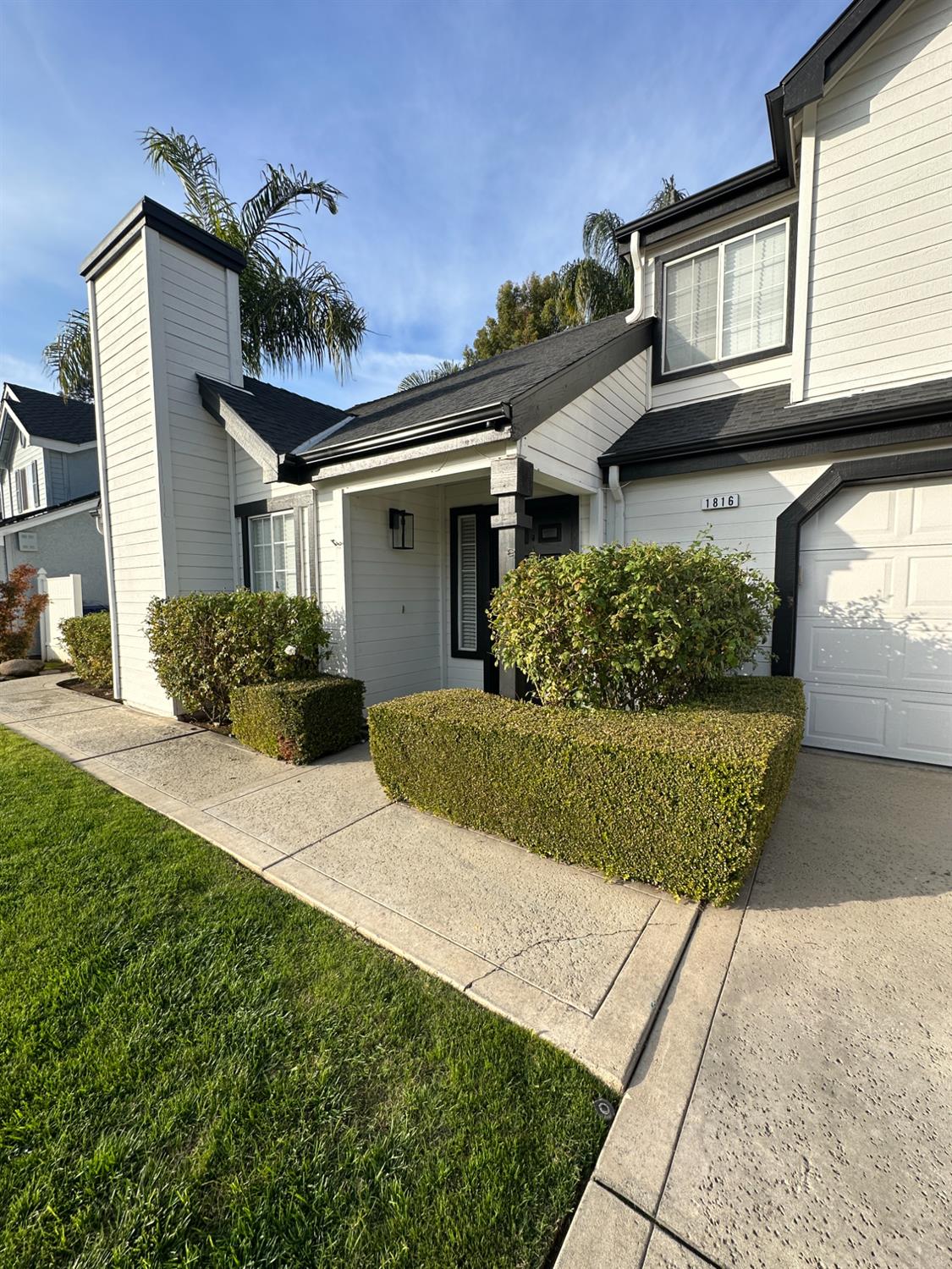 1816 East Frederick Avenue Fresno, CA 93720 - Photo 2 of 29 a front view of a house with a yard and potted plants
