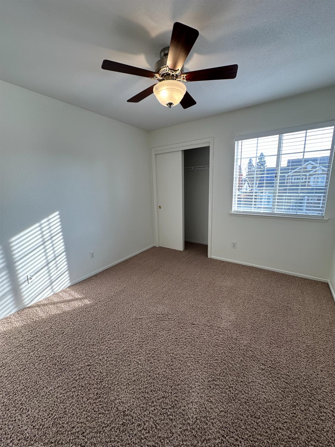1816 East Frederick Avenue Fresno, CA 93720 - Photo 23 of 29 an empty room with windows and ceiling fan
