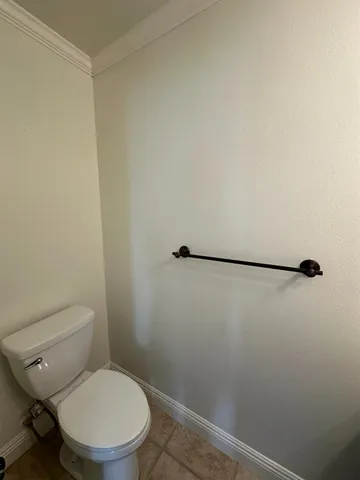 a white toilet sitting next to a shower