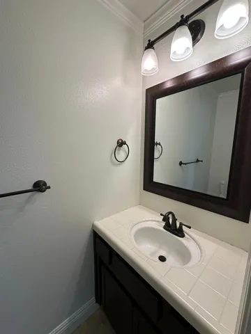 a bathroom with a sink vanity and a mirror