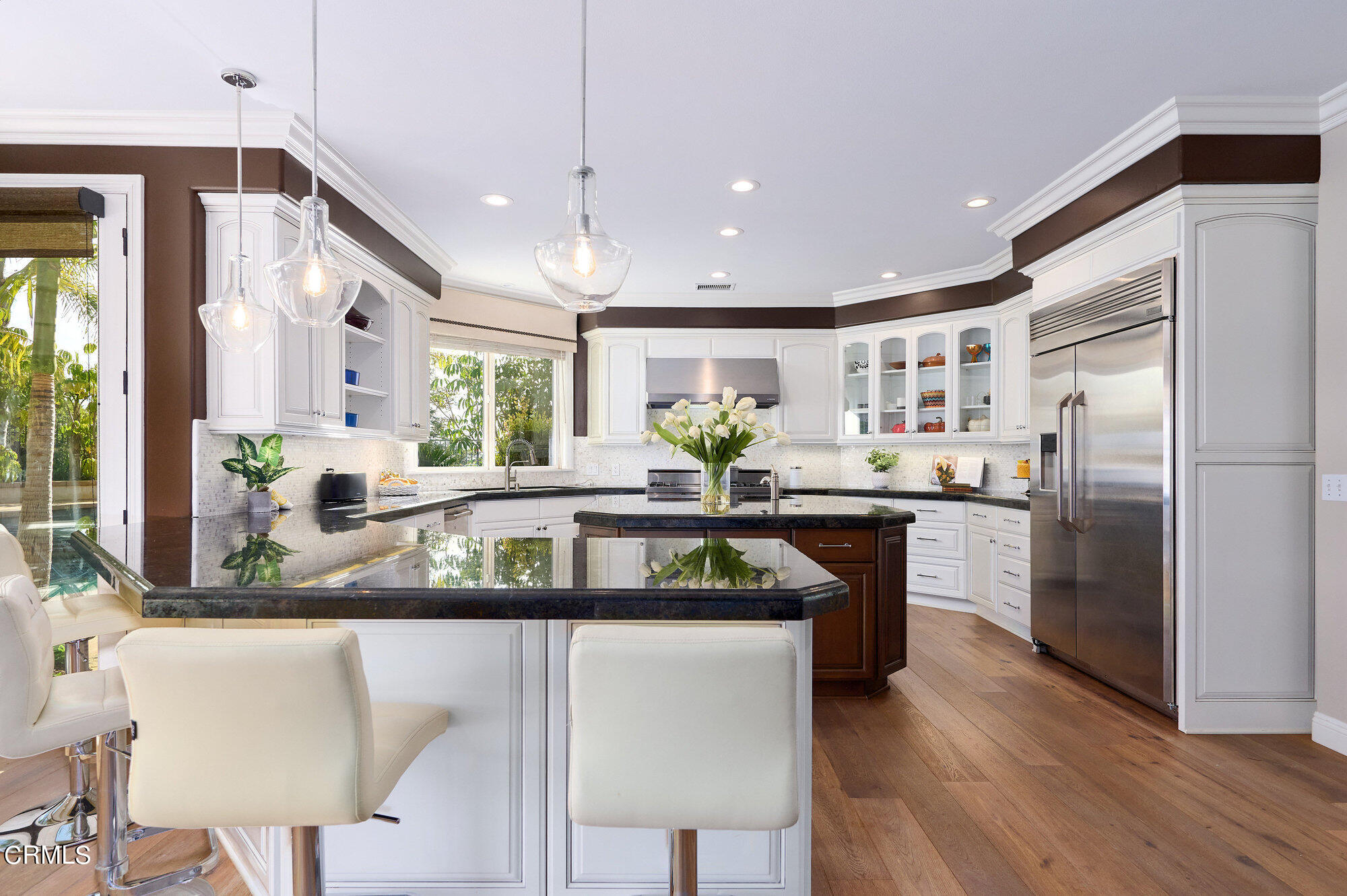 7159 Los Coyotes Place Camarillo, CA 93012 - Photo 17 of 73 a kitchen with stainless steel appliances granite countertop a refrigerator a stove a sink a dining table and chairs