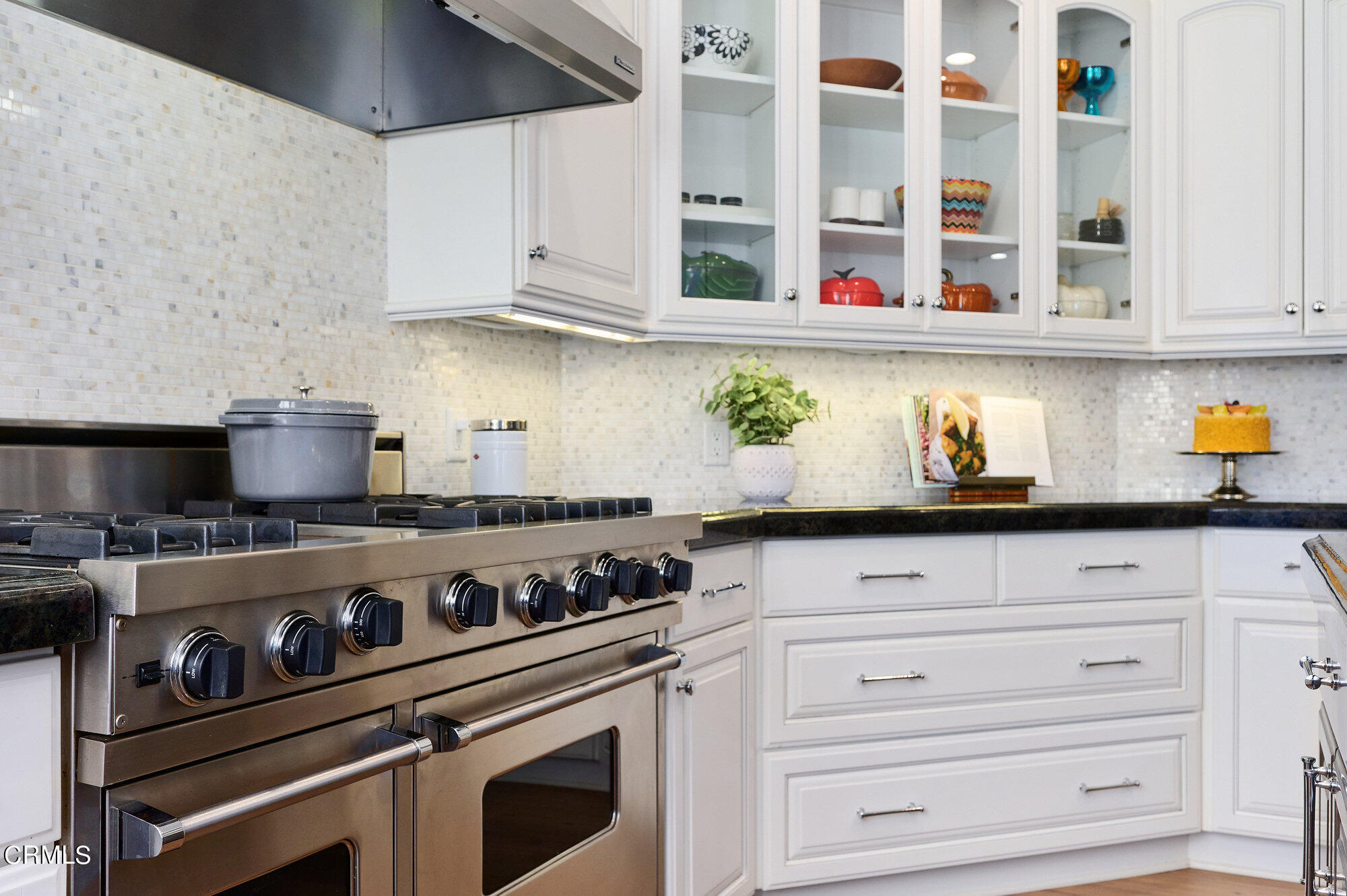 7159 Los Coyotes Place Camarillo, CA 93012 - Photo 21 of 73 a kitchen with stainless steel appliances granite countertop a stove and a white cabinets