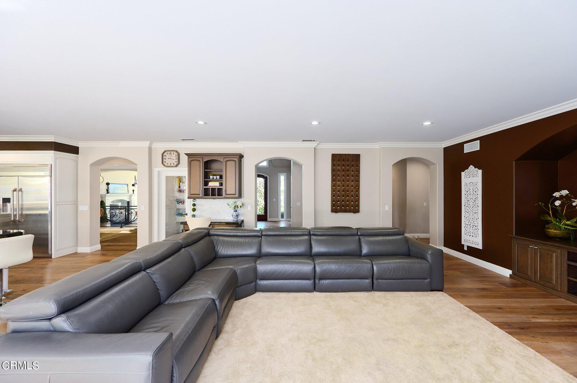 7159 Los Coyotes Place Camarillo, CA 93012 - Photo 24 of 73 a living room with couches and kitchen view with wooden floor