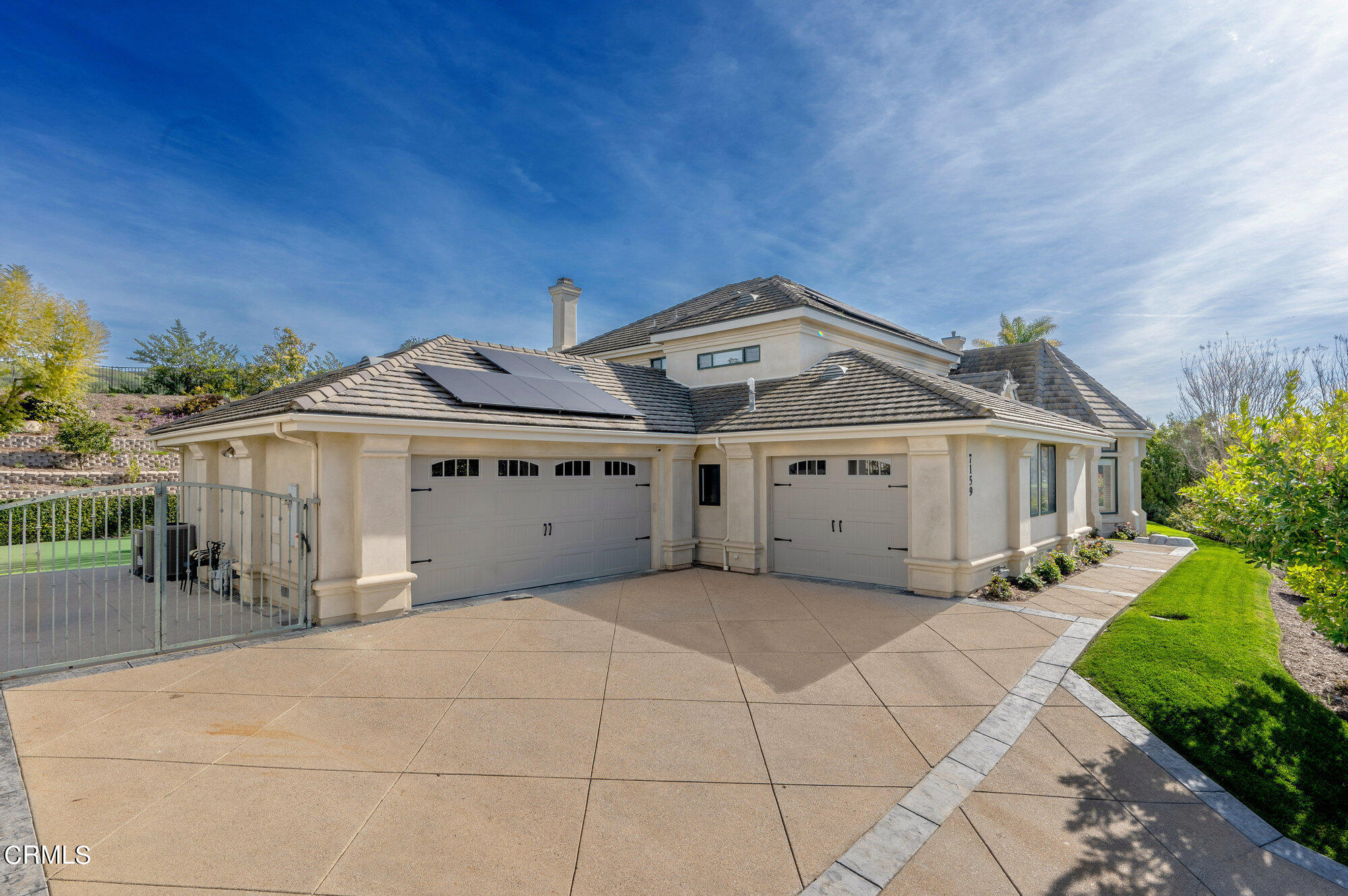 7159 Los Coyotes Place Camarillo, CA 93012 - Photo 63 of 73 a front view of a house with a garden and parking space