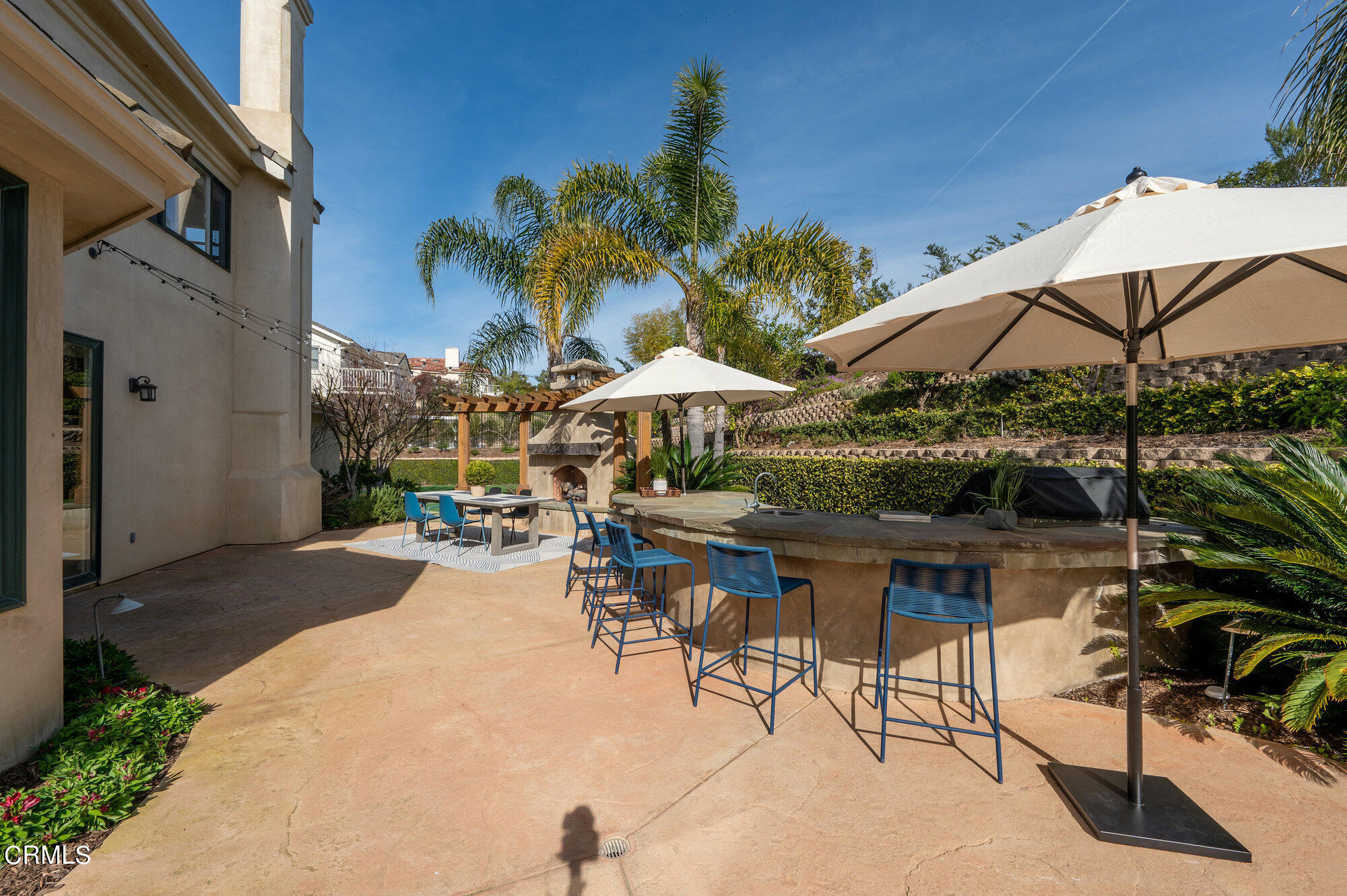 7159 Los Coyotes Place Camarillo, CA 93012 - Photo 67 of 73 a view of patio with chairs and table under an umbrella