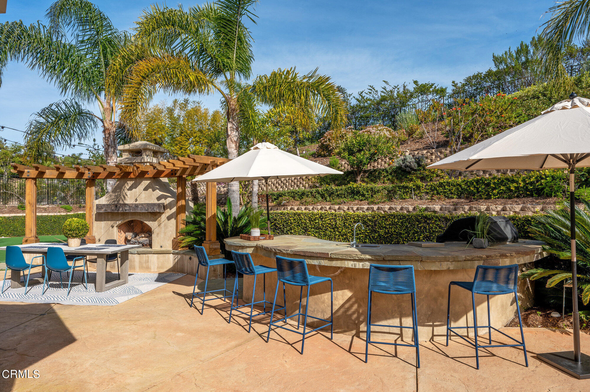 7159 Los Coyotes Place Camarillo, CA 93012 - Photo 10 of 73 a view of patio with chairs and table under an umbrella