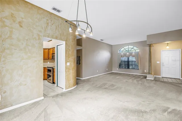 an empty room with windows and painted walls