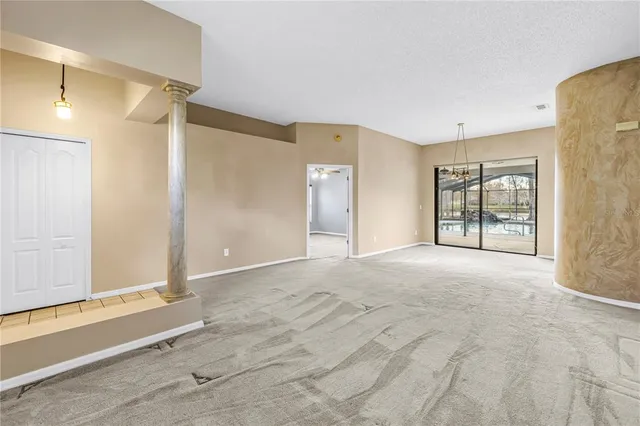 an empty room with windows and mirror