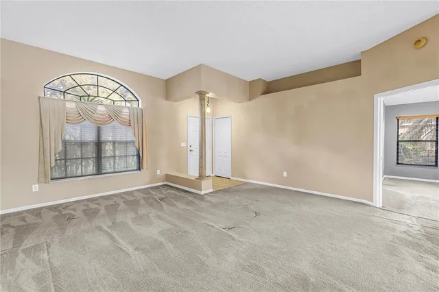 an aerial view of residential houses with outdoor space and trees