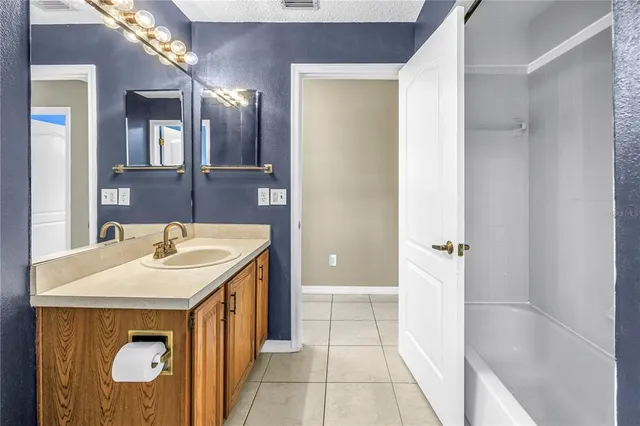 a bathroom with a double vanity sink and a window
