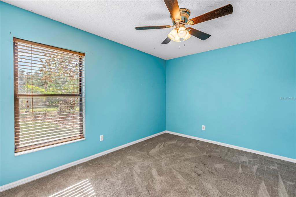 8436 Ridgebrook Circle Odessa, FL 33556 - Photo 42 of 58 an empty room with a window and a fan