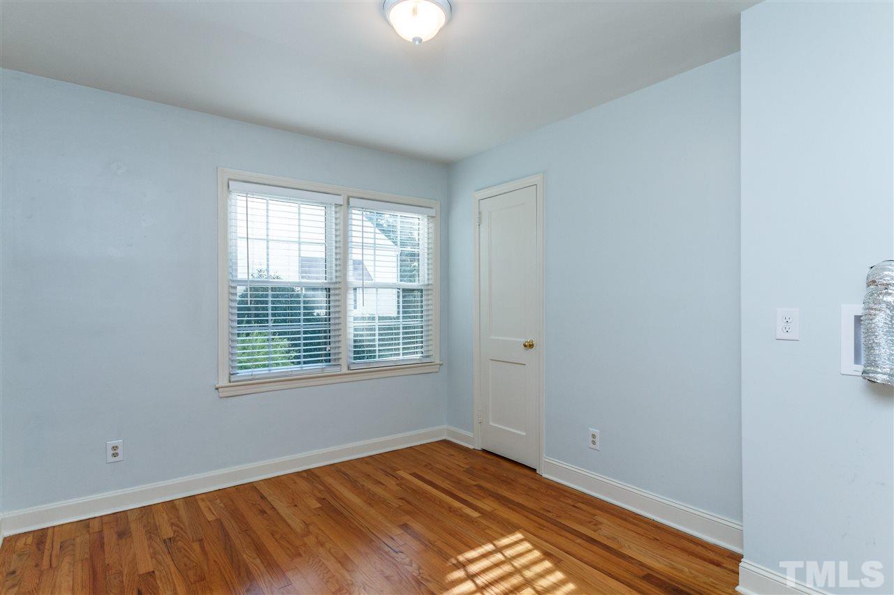 607 Frank Street Raleigh, NC 27604 - Photo 11 of 23 a view of an empty room with wooden floor and a window