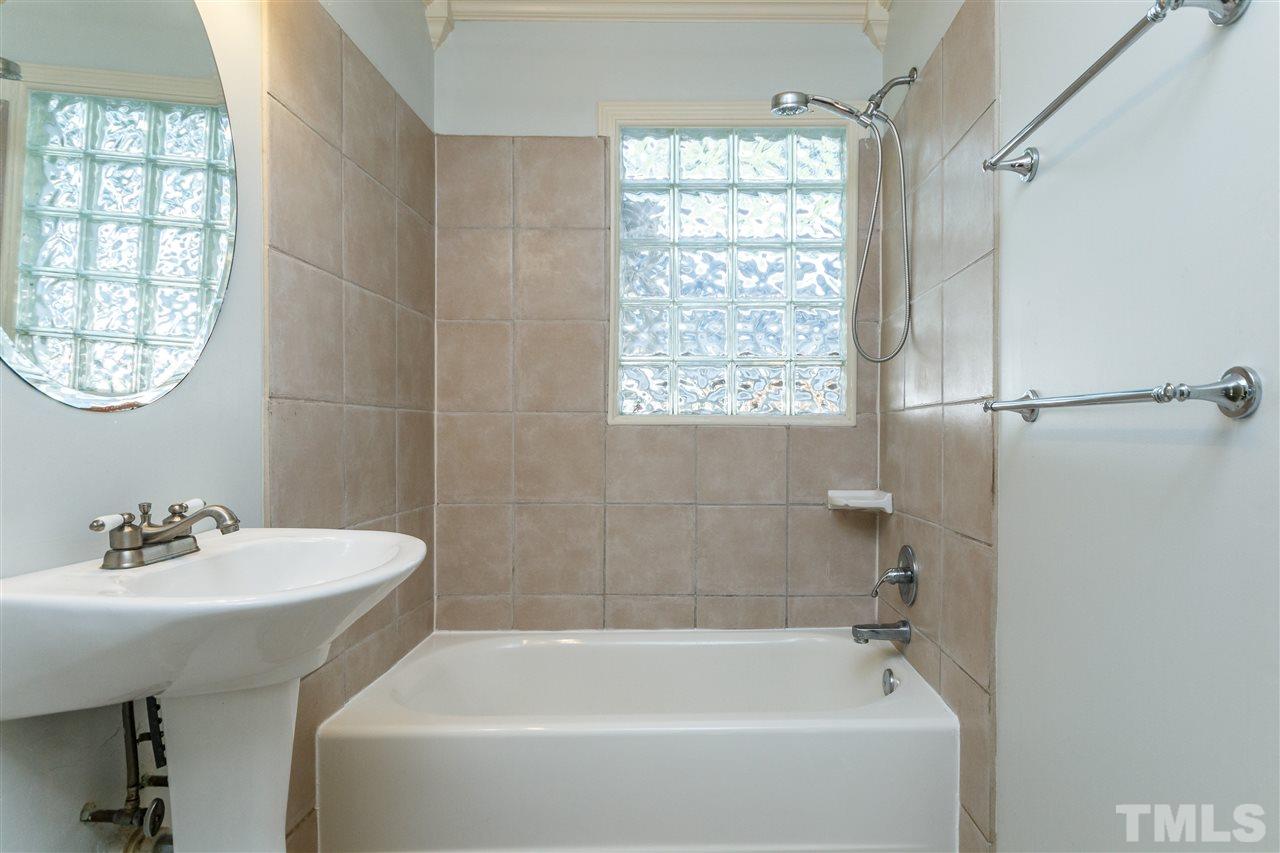 607 Frank Street Raleigh, NC 27604 - Photo 16 of 23 a white bath tub sitting next to a white sink
