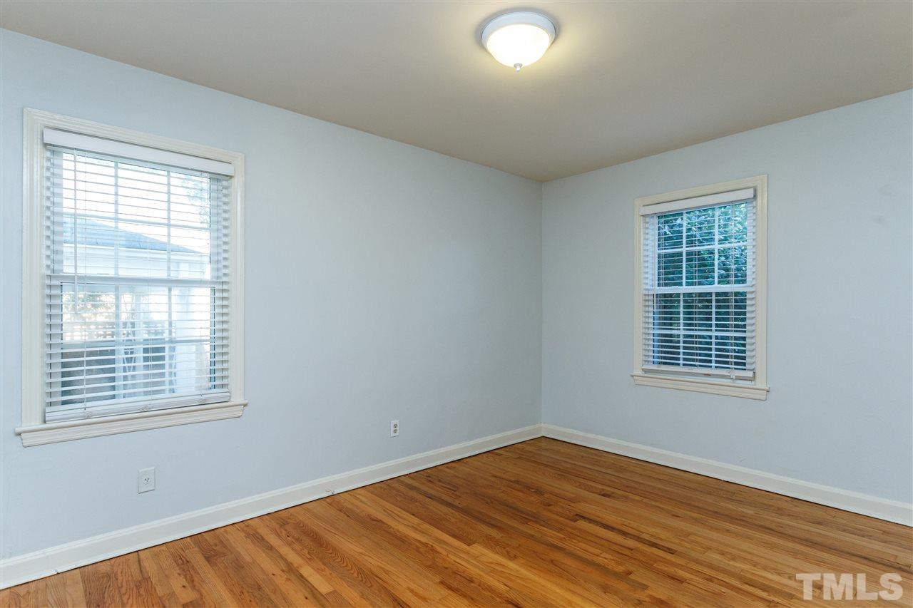 607 Frank Street Raleigh, NC 27604 - Photo 17 of 23 an empty room with wooden floor and windows