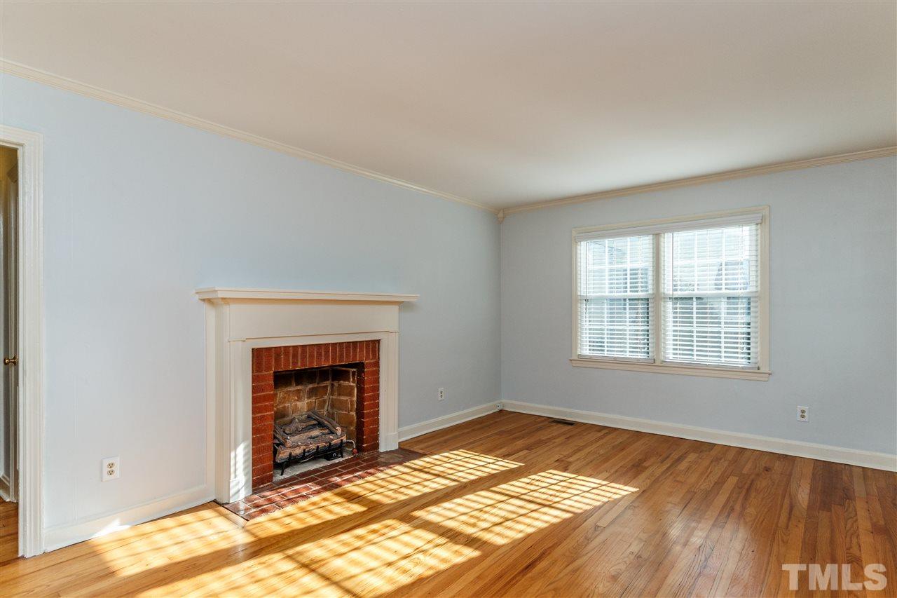 607 Frank Street Raleigh, NC 27604 - Photo 4 of 23 a view of an empty room with wooden floor and a window