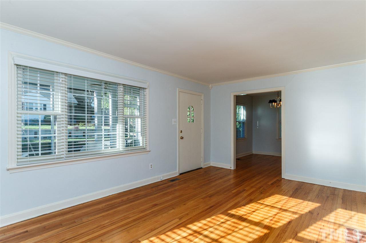 607 Frank Street Raleigh, NC 27604 - Photo 6 of 23 a view of an empty room with wooden floor and a window