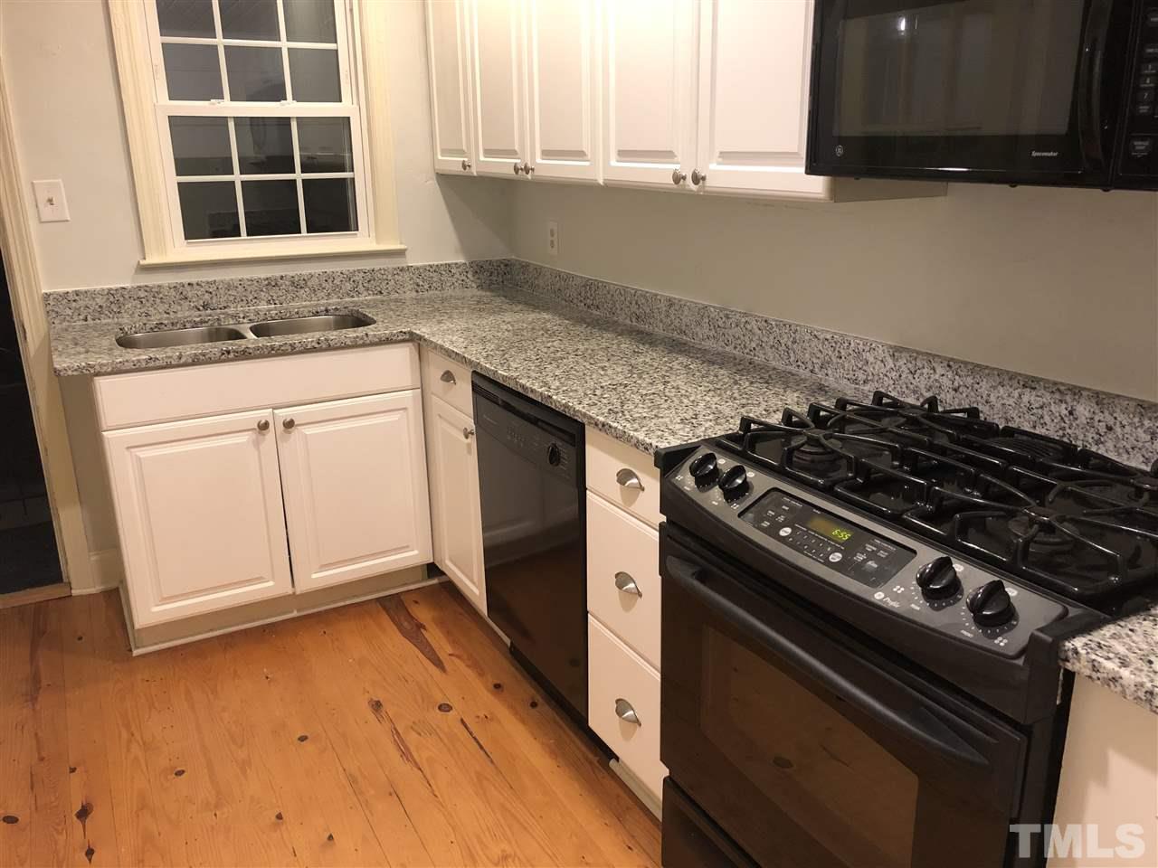 607 Frank Street Raleigh, NC 27604 - Photo 9 of 23 a kitchen with granite countertop a stove and a sink