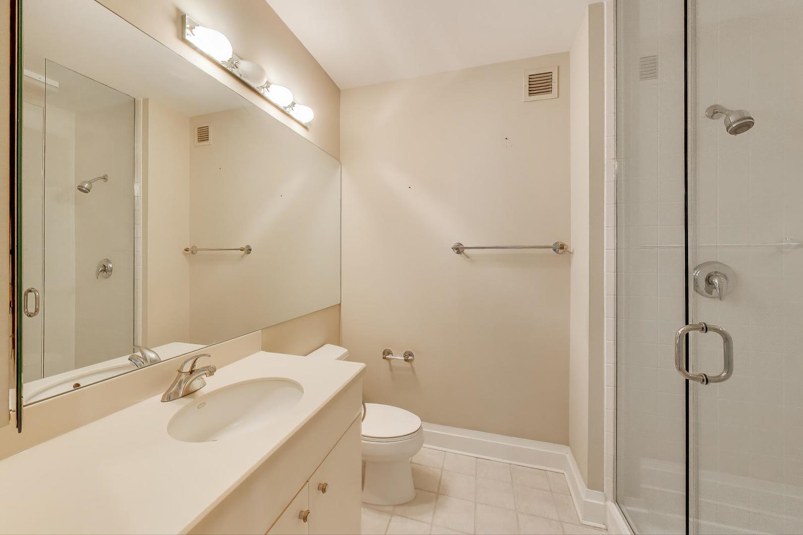 33 West Ontario Street, Unit 30G Chicago, IL 60654 - Photo 14 of 25 a bathroom with a sink toilet and shower