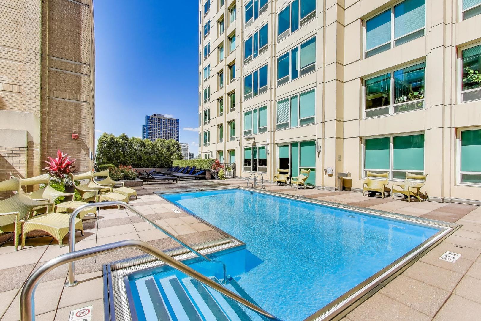 33 West Ontario Street, Unit 30G Chicago, IL 60654 - Photo 17 of 25 a view of a swimming pool with chairs and tables