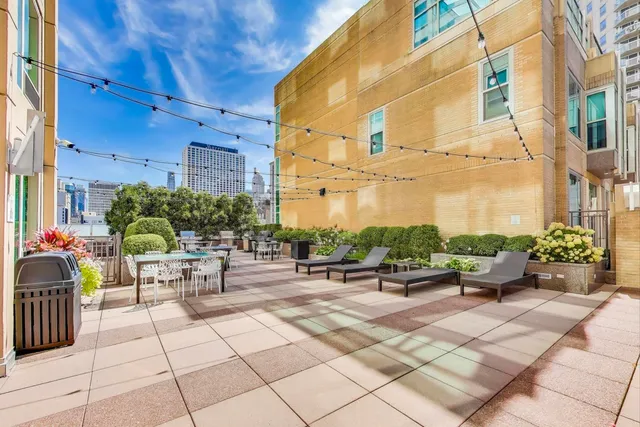 a view of a patio with dining table and chairs