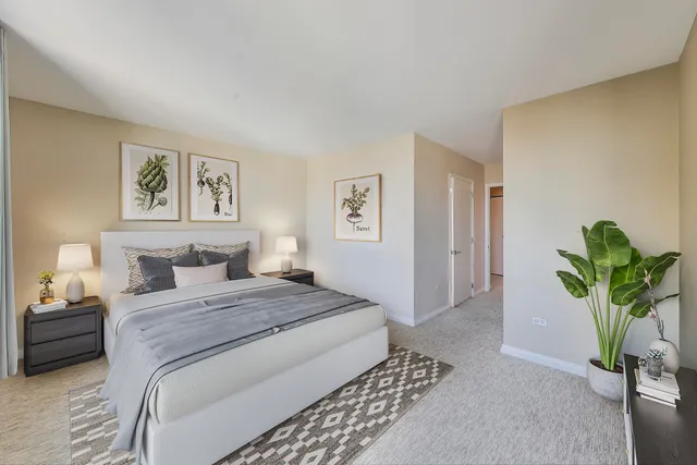 a bedroom with a bed and a potted plant
