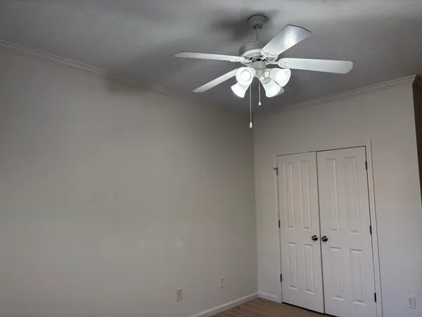 a view of a chandelier fan and wooden floor
