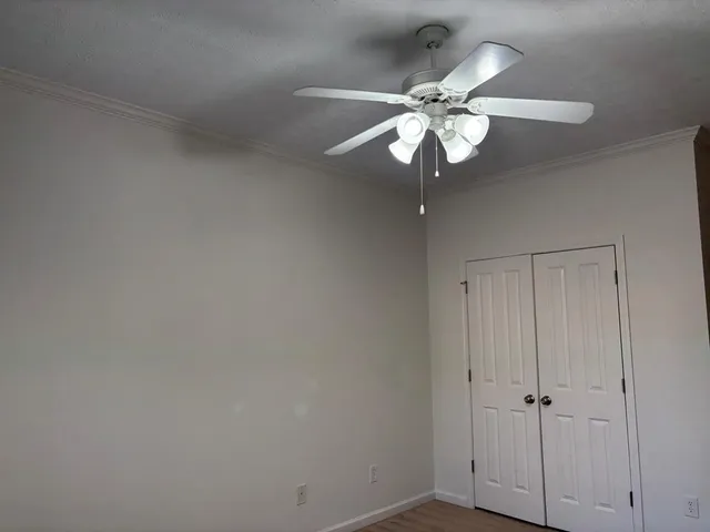 a view of a chandelier fan and wooden floor