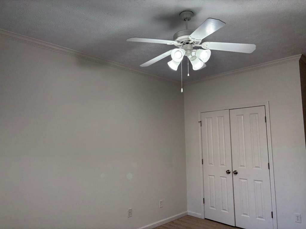 8001 Adelaide Drive Columbus, GA 31909 - Photo 15 of 36 a view of a chandelier fan and wooden floor