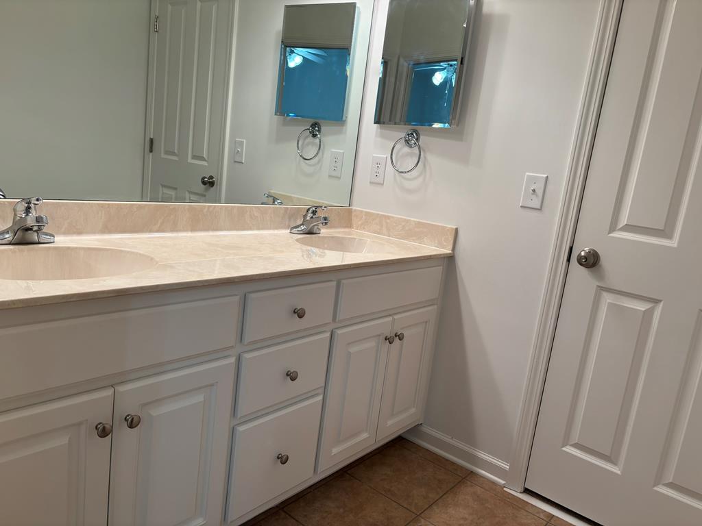 8001 Adelaide Drive Columbus, GA 31909 - Photo 17 of 36 a bathroom with a double vanity sink and mirror