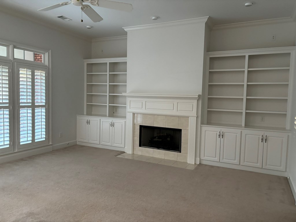 8001 Adelaide Drive Columbus, GA 31909 - Photo 2 of 36 a view of an empty room with a fireplace and a window