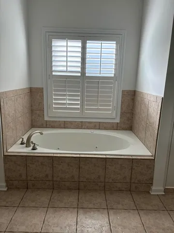 a bathroom with a bathtub and a window