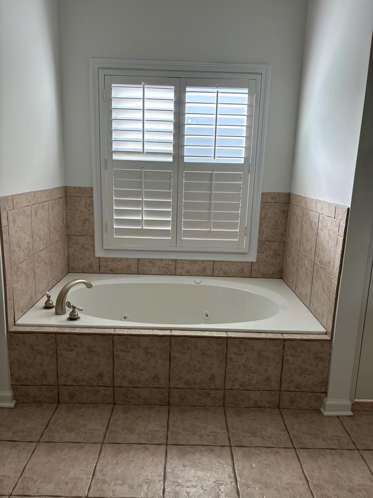 8001 Adelaide Drive Columbus, GA 31909 - Photo 23 of 36 a bathroom with a bathtub and a window