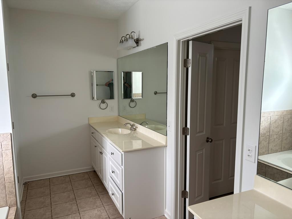 8001 Adelaide Drive Columbus, GA 31909 - Photo 24 of 36 a bathroom with a double vanity sink and mirror