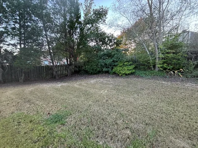 a view of a backyard with large trees
