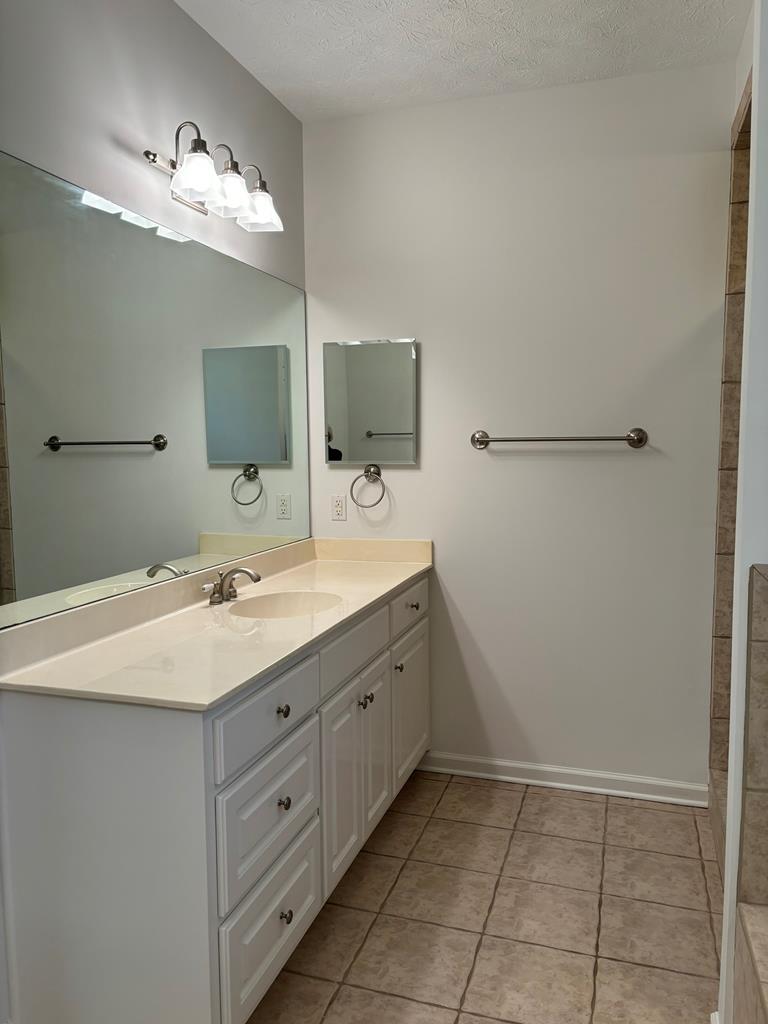 8001 Adelaide Drive Columbus, GA 31909 - Photo 32 of 36 a bathroom with a sink vanity and mirror