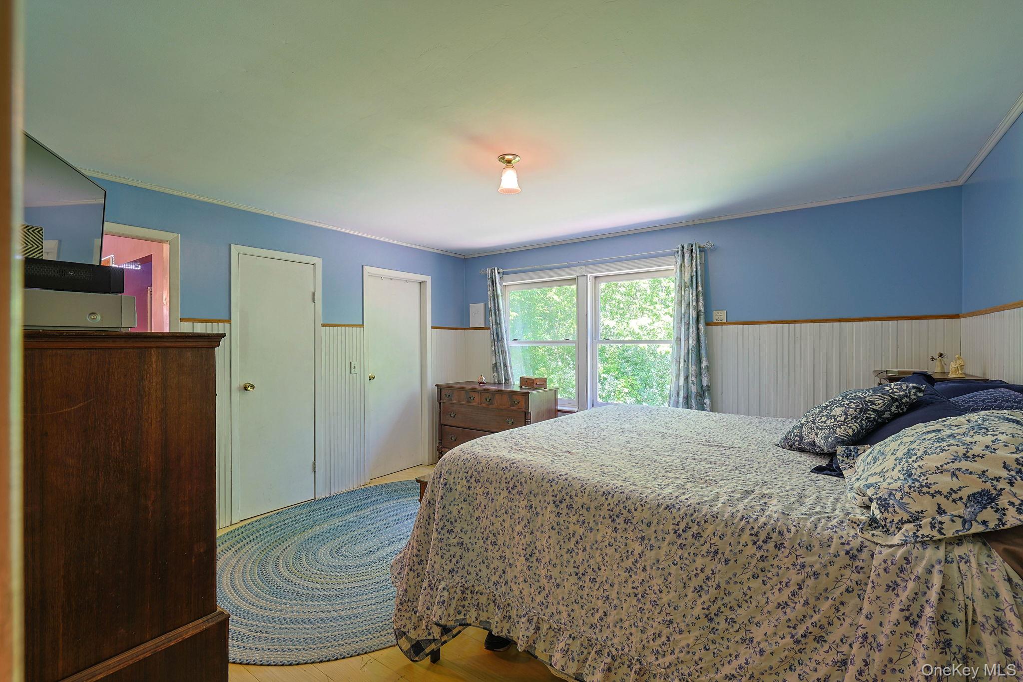 646 County Rte 93 Slate Hill, NY 10973 - Photo 12 of 21 Bedroom featuring wood-finish flooring, two windows with trim, and a ceiling-mounted light fixture