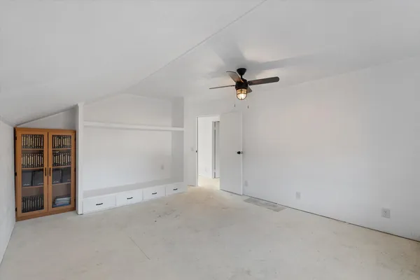 an empty room with a empty space and windows