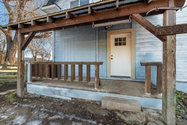 a front view of a house with wooden fence