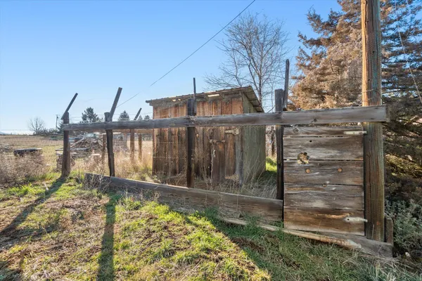 a view of a pathway with a wrought fence