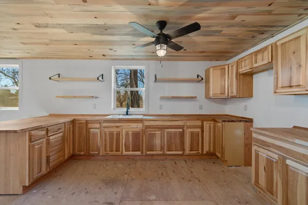 a kitchen with granite countertop a sink stainless steel appliances and cabinets