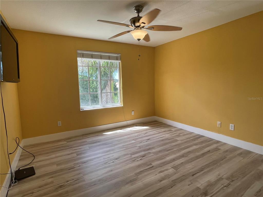 759 Fordingbridge Way Osprey, FL 34229 - Photo 6 of 51 a view of an empty room with wooden floor and a window